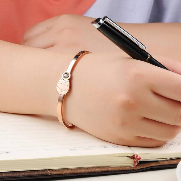 rose gold cat bracelet on human wrist