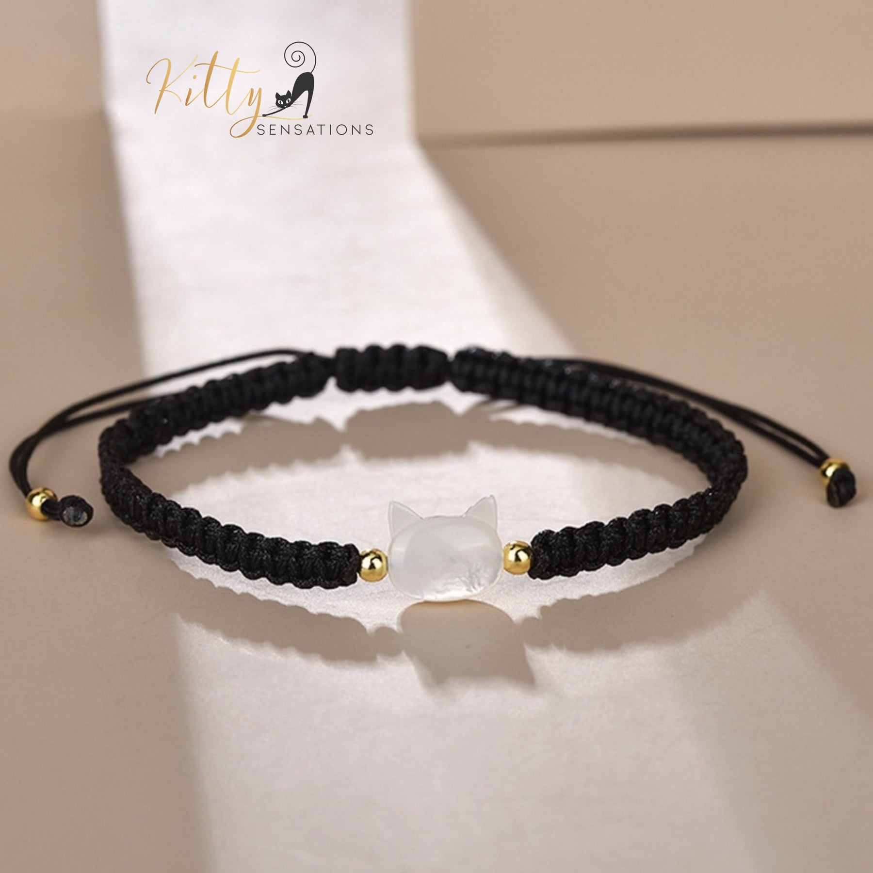 www.KittySensations.com: Natural Mother-of-Pearl and Braided Cord Cat Bracelet (Adjustable Size) ($20.40): https://www.kittysensations.com/products/mother-of-pearl-and-braided-cord-cat-bracelet-adjustable-size
