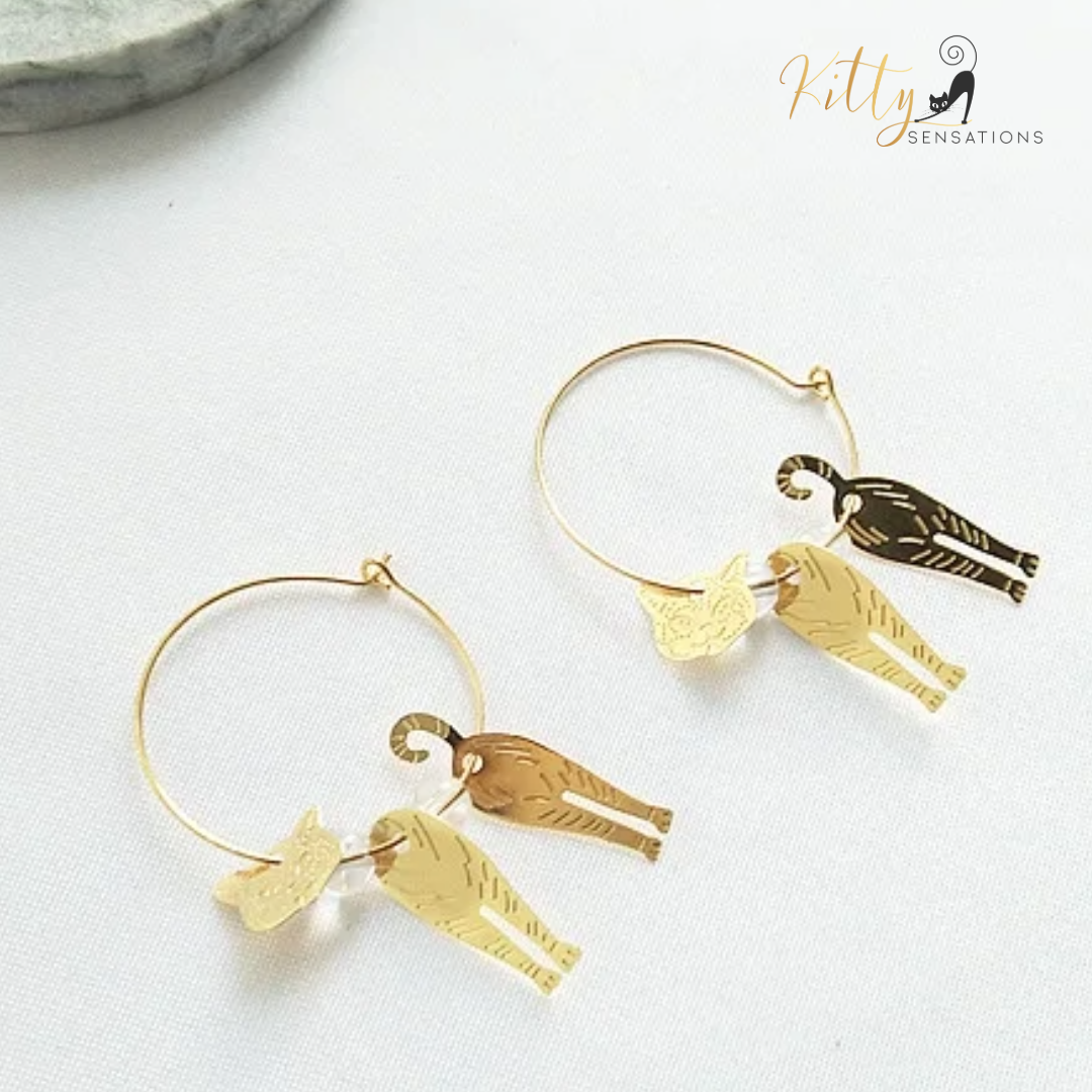 Moving Cat Hoop Earrings - Bronze-Gold Color: These absolutely gorgeous and dynamic earrings are a must have for a cat loving lady. The subtle bronze-gold colored earrings show pierced profiles of a cute kitty in three different bronze-gold colored foils that move as you move, depicting the graceful movements of your lovely cat. https://www.kittysensations.com/products/moving-cat-hoop-earrings