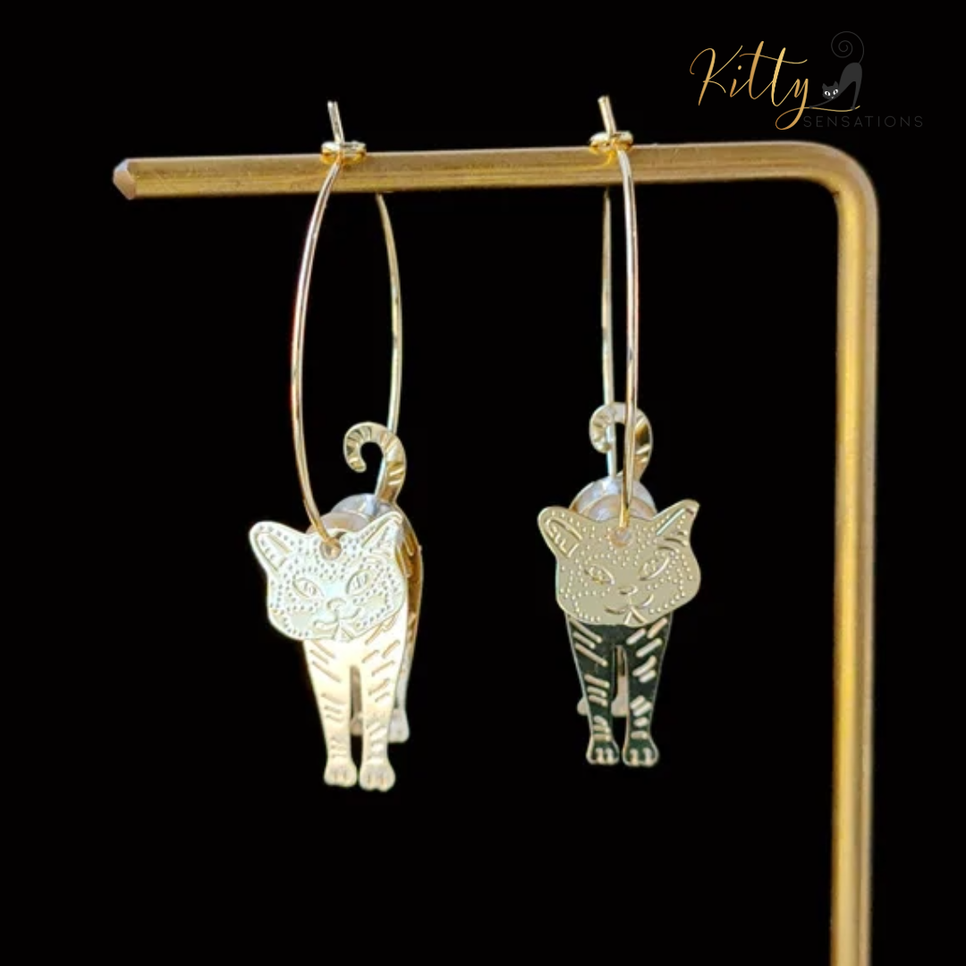 Moving Cat Hoop Earrings - Bronze-Gold Color: These absolutely gorgeous and dynamic earrings are a must have for a cat loving lady. The subtle bronze-gold colored earrings show pierced profiles of a cute kitty in three different bronze-gold colored foils that move as you move, depicting the graceful movements of your lovely cat. https://www.kittysensations.com/products/moving-cat-hoop-earrings