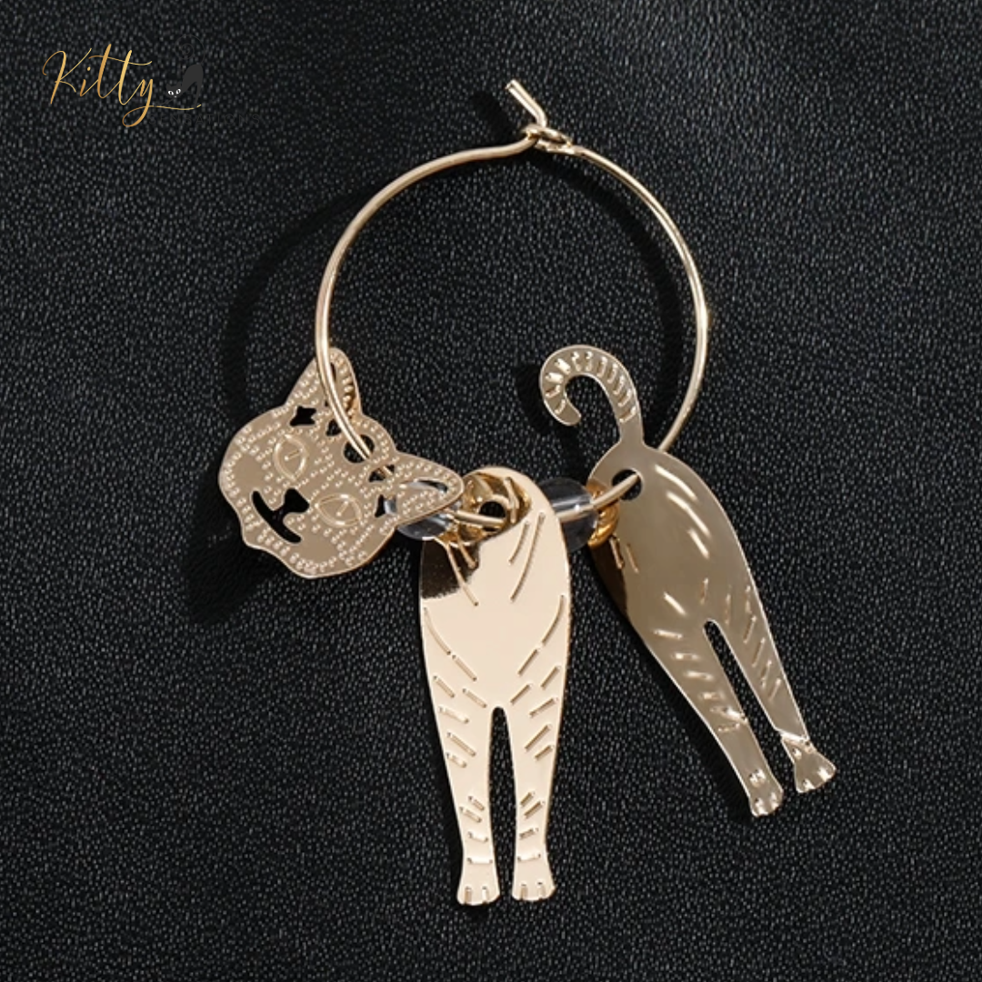 Moving Cat Hoop Earrings - Bronze-Gold Color: These absolutely gorgeous and dynamic earrings are a must have for a cat loving lady. The subtle bronze-gold colored earrings show pierced profiles of a cute kitty in three different bronze-gold colored foils that move as you move, depicting the graceful movements of your lovely cat. https://www.kittysensations.com/products/moving-cat-hoop-earrings