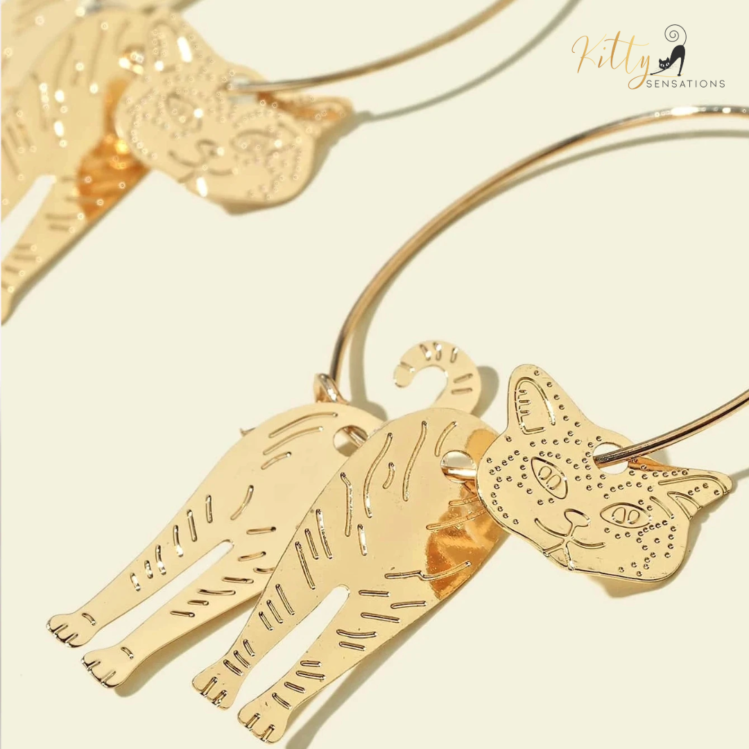 Moving Cat Hoop Earrings - Bronze-Gold Color: These absolutely gorgeous and dynamic earrings are a must have for a cat loving lady. The subtle bronze-gold colored earrings show pierced profiles of a cute kitty in three different bronze-gold colored foils that move as you move, depicting the graceful movements of your lovely cat. https://www.kittysensations.com/products/moving-cat-hoop-earrings