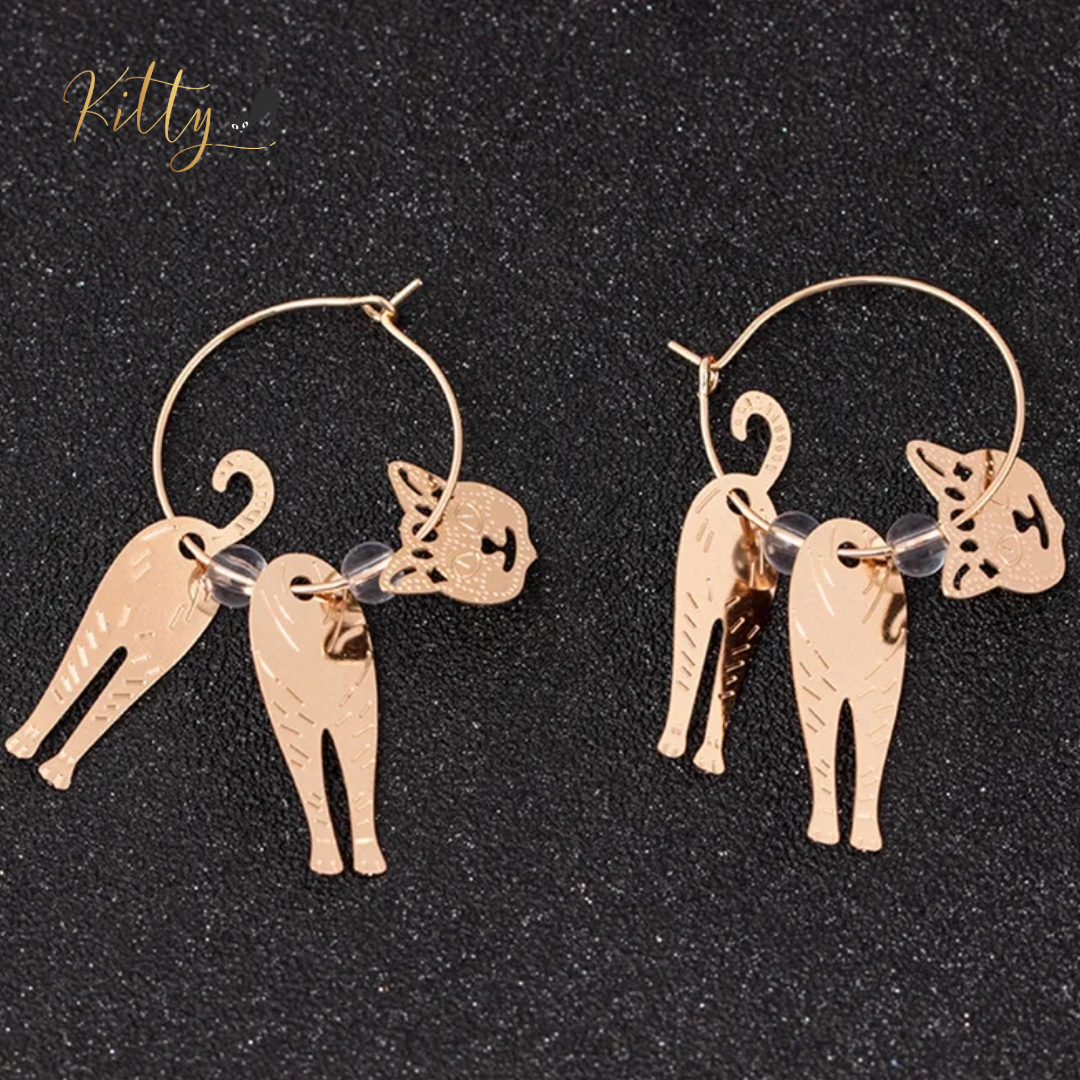 Moving Cat Hoop Earrings - Bronze-Gold Color: These absolutely gorgeous and dynamic earrings are a must have for a cat loving lady. The subtle bronze-gold colored earrings show pierced profiles of a cute kitty in three different bronze-gold colored foils that move as you move, depicting the graceful movements of your lovely cat. https://www.kittysensations.com/products/moving-cat-hoop-earrings