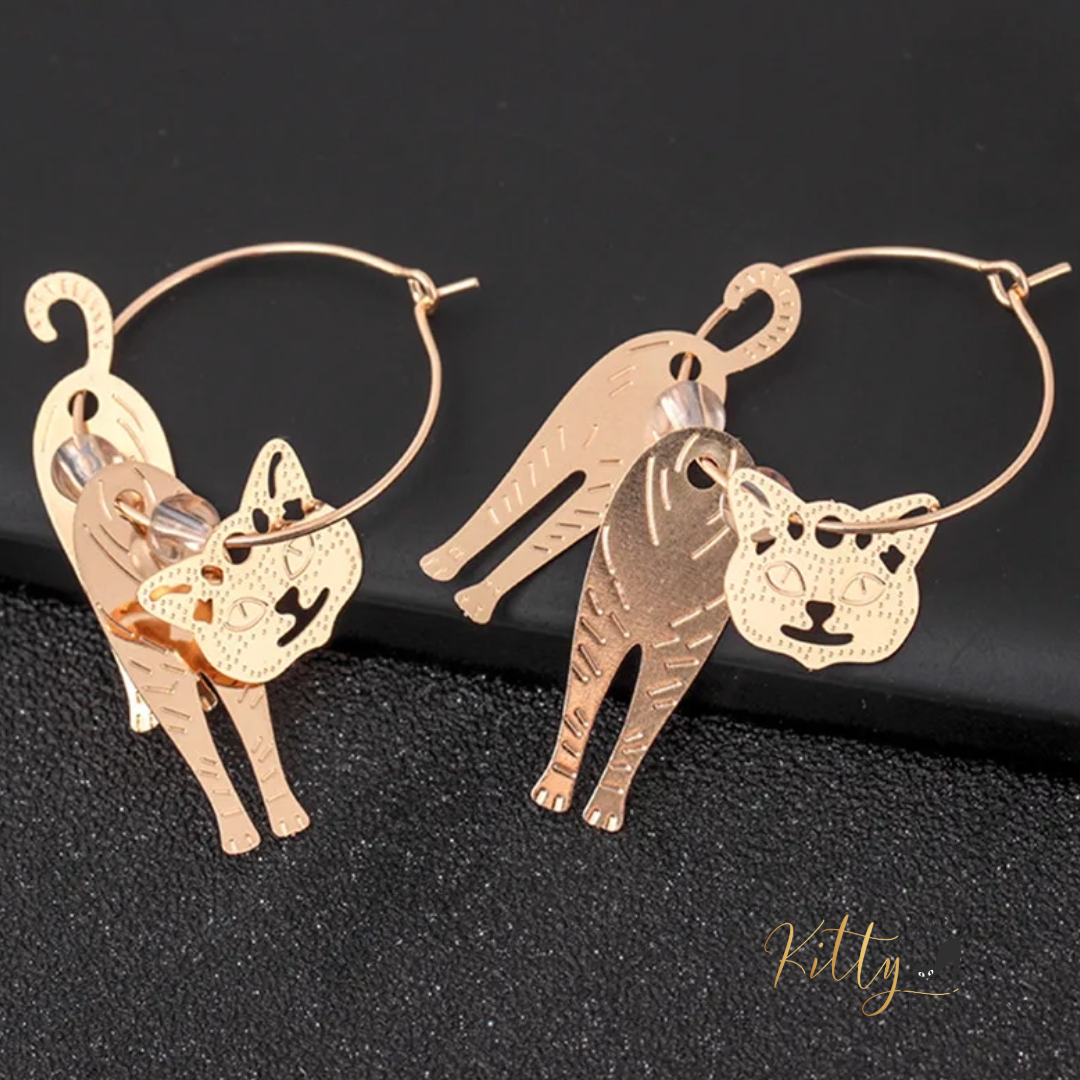 Moving Cat Hoop Earrings - Bronze-Gold Color: These absolutely gorgeous and dynamic earrings are a must have for a cat loving lady. The subtle bronze-gold colored earrings show pierced profiles of a cute kitty in three different bronze-gold colored foils that move as you move, depicting the graceful movements of your lovely cat.  https://www.kittysensations.com/products/moving-cat-hoop-earrings