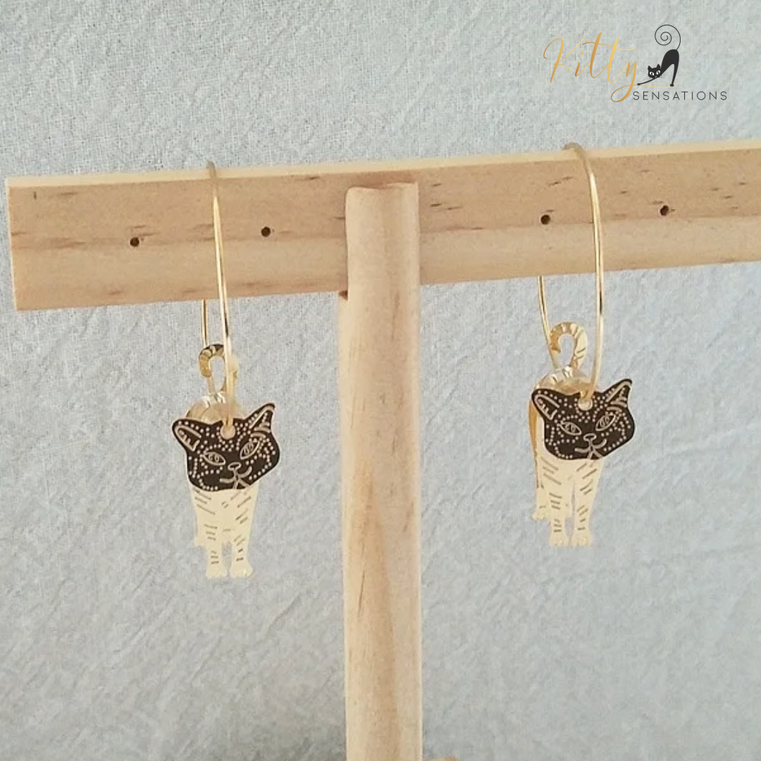 Moving Cat Hoop Earrings - Bronze-Gold Color: These absolutely gorgeous and dynamic earrings are a must have for a cat loving lady. The subtle bronze-gold colored earrings show pierced profiles of a cute kitty in three different bronze-gold colored foils that move as you move, depicting the graceful movements of your lovely cat. https://www.kittysensations.com/products/moving-cat-hoop-earrings