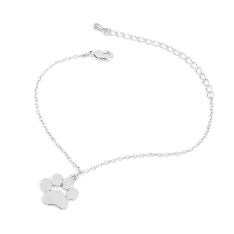 silver cat paw bracelet on white surface