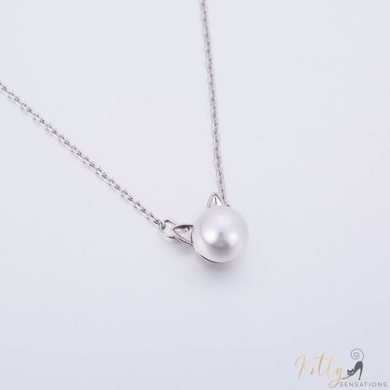 pearl cat necklace in sterling silver lying on gray surface 5770505-silver-plated