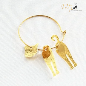 Moving Cat Hoop Earrings - Bronze-Gold Color: These absolutely gorgeous and dynamic earrings are a must have for a cat loving lady. The subtle bronze-gold colored earrings show pierced profiles of a cute kitty in three different bronze-gold colored foils that move as you move, depicting the graceful movements of your lovely cat.  https://www.kittysensations.com/products/moving-cat-hoop-earrings