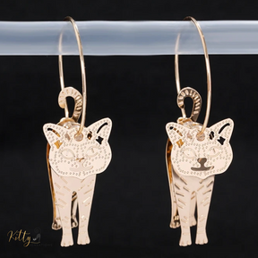 Moving Cat Hoop Earrings - Bronze-Gold Color: These absolutely gorgeous and dynamic earrings are a must have for a cat loving lady. The subtle bronze-gold colored earrings show pierced profiles of a cute kitty in three different bronze-gold colored foils that move as you move, depicting the graceful movements of your lovely cat.  https://www.kittysensations.com/products/moving-cat-hoop-earrings