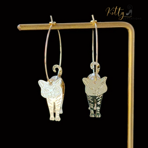 Moving Cat Hoop Earrings - Bronze-Gold Color: These absolutely gorgeous and dynamic earrings are a must have for a cat loving lady. The subtle bronze-gold colored earrings show pierced profiles of a cute kitty in three different bronze-gold colored foils that move as you move, depicting the graceful movements of your lovely cat.  https://www.kittysensations.com/products/moving-cat-hoop-earrings