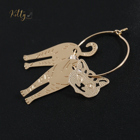 Moving Cat Hoop Earrings - Bronze-Gold Color: These absolutely gorgeous and dynamic earrings are a must have for a cat loving lady. The subtle bronze-gold colored earrings show pierced profiles of a cute kitty in three different bronze-gold colored foils that move as you move, depicting the graceful movements of your lovely cat.  https://www.kittysensations.com/products/moving-cat-hoop-earrings