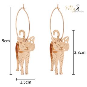 Moving Cat Hoop Earrings - Bronze-Gold Color: These absolutely gorgeous and dynamic earrings are a must have for a cat loving lady. The subtle bronze-gold colored earrings show pierced profiles of a cute kitty in three different bronze-gold colored foils that move as you move, depicting the graceful movements of your lovely cat.  https://www.kittysensations.com/products/moving-cat-hoop-earrings