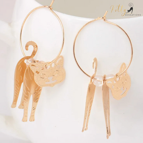 Moving Cat Hoop Earrings - Bronze-Gold Color: These absolutely gorgeous and dynamic earrings are a must have for a cat loving lady. The subtle bronze-gold colored earrings show pierced profiles of a cute kitty in three different bronze-gold colored foils that move as you move, depicting the graceful movements of your lovely cat.  https://www.kittysensations.com/products/moving-cat-hoop-earrings