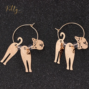 Moving Cat Hoop Earrings - Bronze-Gold Color: These absolutely gorgeous and dynamic earrings are a must have for a cat loving lady. The subtle bronze-gold colored earrings show pierced profiles of a cute kitty in three different bronze-gold colored foils that move as you move, depicting the graceful movements of your lovely cat.  https://www.kittysensations.com/products/moving-cat-hoop-earrings