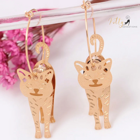 Moving Cat Hoop Earrings - Bronze-Gold Color: These absolutely gorgeous and dynamic earrings are a must have for a cat loving lady. The subtle bronze-gold colored earrings show pierced profiles of a cute kitty in three different bronze-gold colored foils that move as you move, depicting the graceful movements of your lovely cat.  https://www.kittysensations.com/products/moving-cat-hoop-earrings