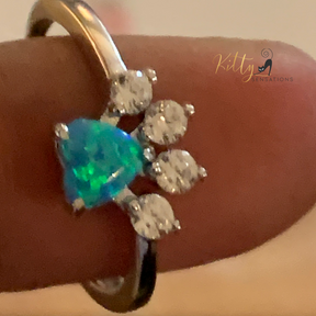 Solid 925 sterling silver cat paw ring with a central heart-shaped blue fire opal stone and four smaller AAA quality clear Cubic Zirconia stones for kitty toes - Rhodium-plated for anti-tarnish and durability.