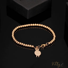 cat charm bracelet plated in rose gold on black surface 4396504-rose-gold-color