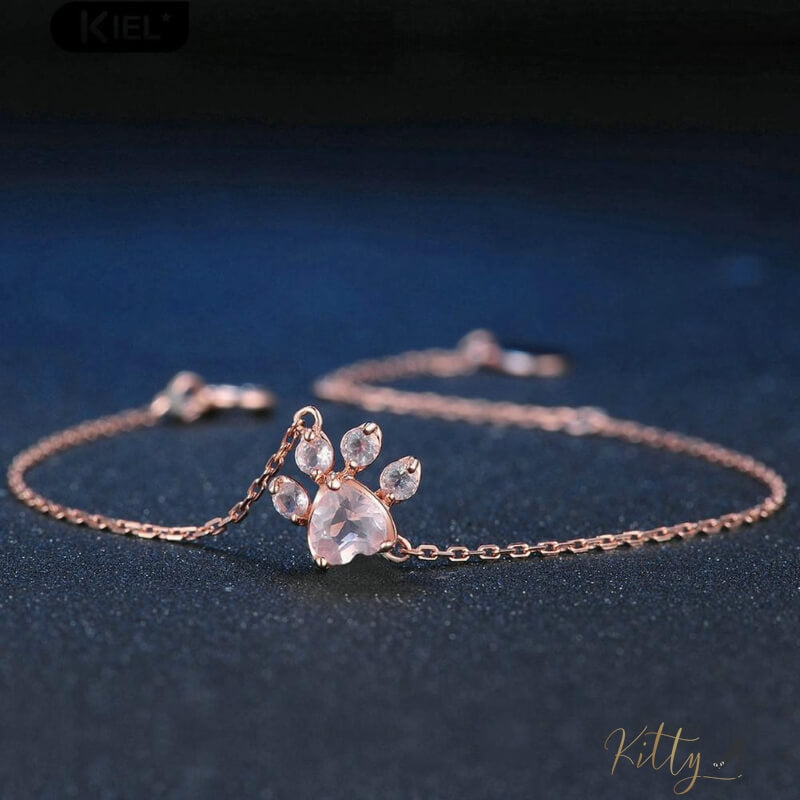 cat paw bracelet plated in rose gold on dark background 13407681-pink