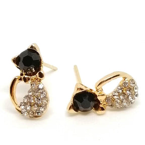 golden cat stud earrings on white surface 4984550-black-cat
