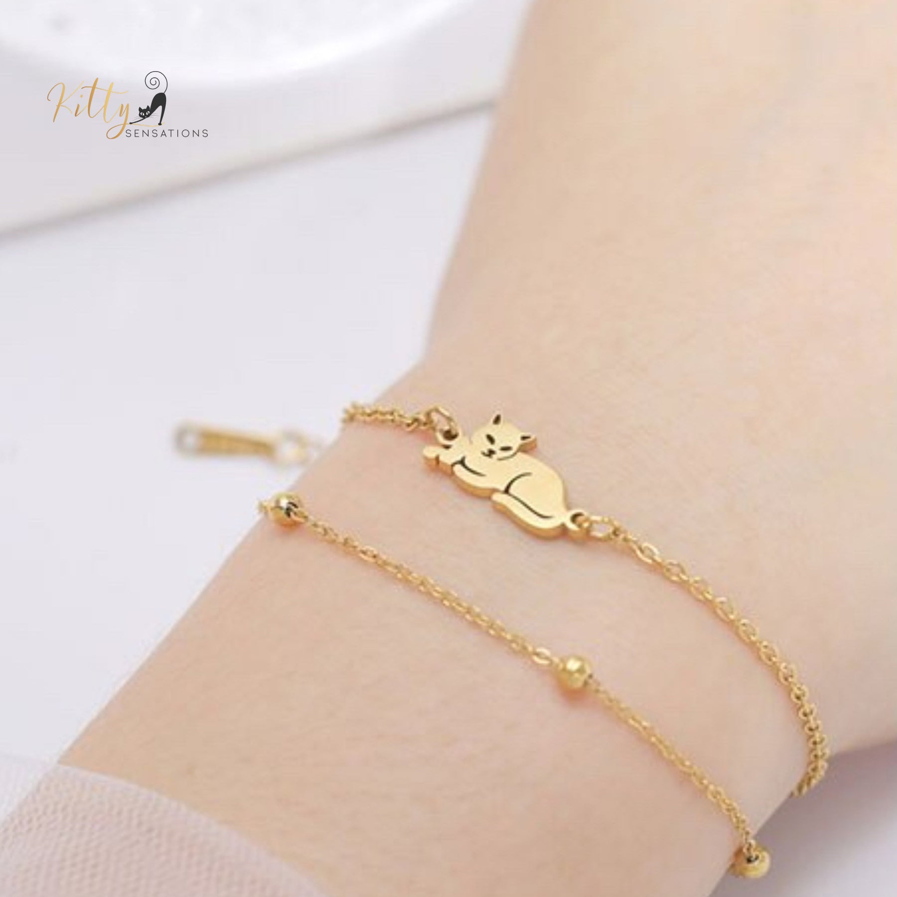 Sitting Cat, Two Chain - Very Feminine - Bracelet (Adjustable Length) ($22.4): https://www.kittysensations.com/products/sitting-kitty-two-chain-very-feminine-bracelet-adjustable-length?variant=40281701974082