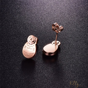 rose gold cat stud earrings lying on black surface 2631595-rose-gold-color