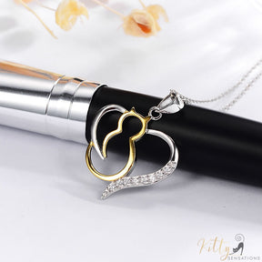 heart cat necklace in silver and gold on white table and black pen 4131000
