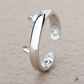 flexible silver cat ring with tiny ears and paws on beige surface 1733147-resizable-gszr0064