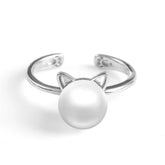 cute silver pearl cat ring with little paws on white surface 15731344-ring