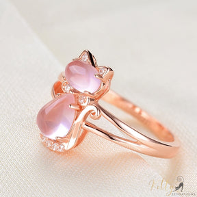 opal cat ring in 14k rose gold on bright surface